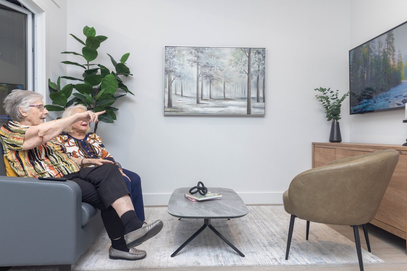 A resident in the living room of a completed Metrosuite home