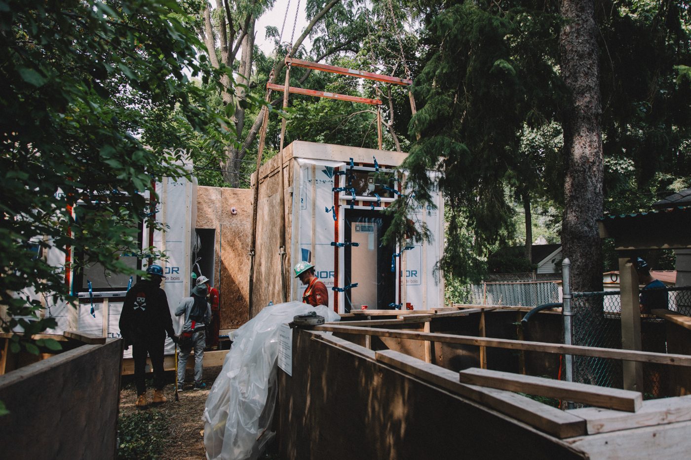 A module set on its poured foundation with the crew alongside